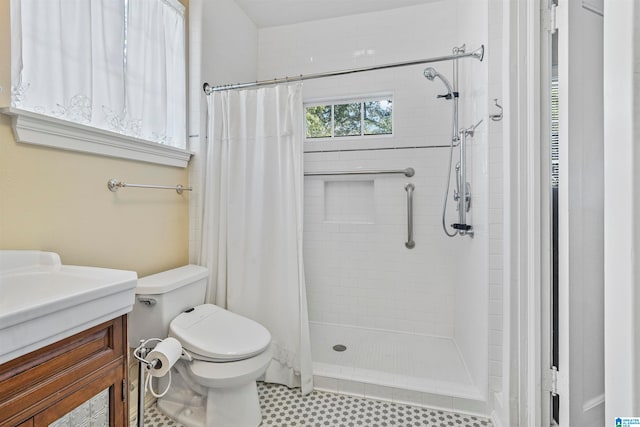 bathroom featuring walk in shower, vanity, and toilet