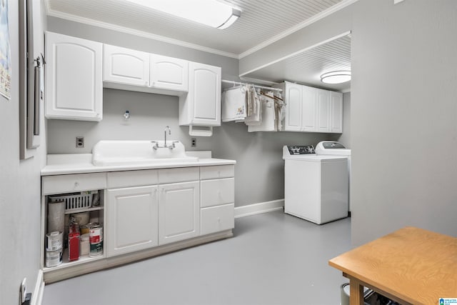 laundry room with sink, cabinets, independent washer and dryer, and ornamental molding