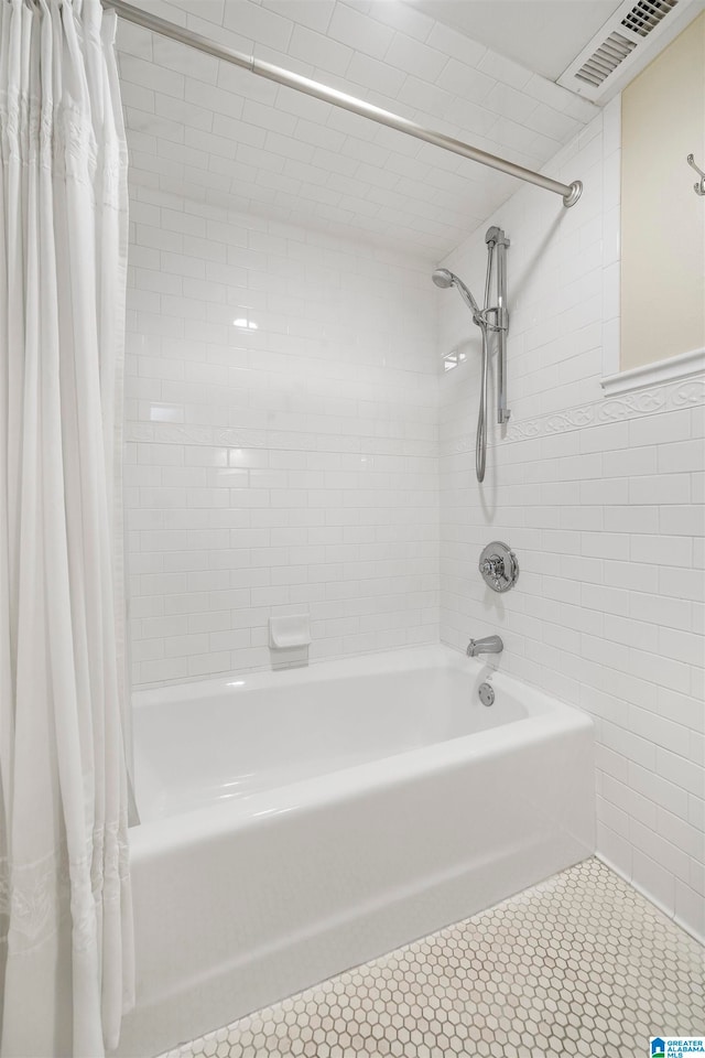 bathroom with shower / tub combo with curtain and tile patterned floors