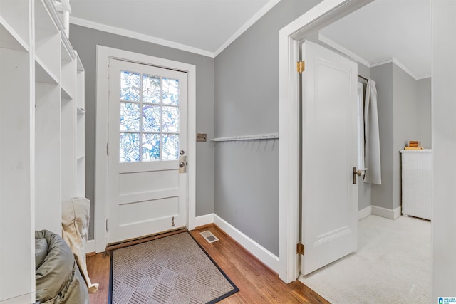 doorway to outside featuring light hardwood / wood-style floors and crown molding