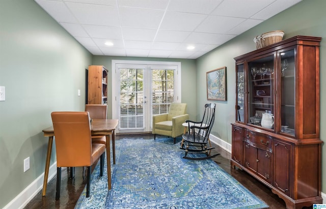 sitting room with dark hardwood / wood-style floors and a paneled ceiling