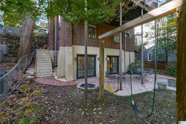 rear view of house with a patio, an outdoor fire pit, and french doors