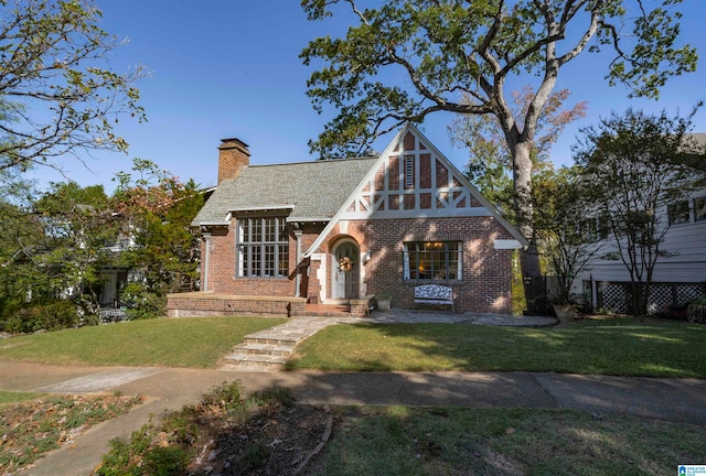 english style home with a front yard