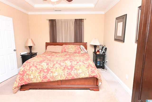 bedroom with ornamental molding, light colored carpet, ceiling fan, and a raised ceiling