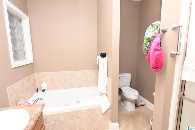 bathroom featuring toilet, vanity, and tiled bath