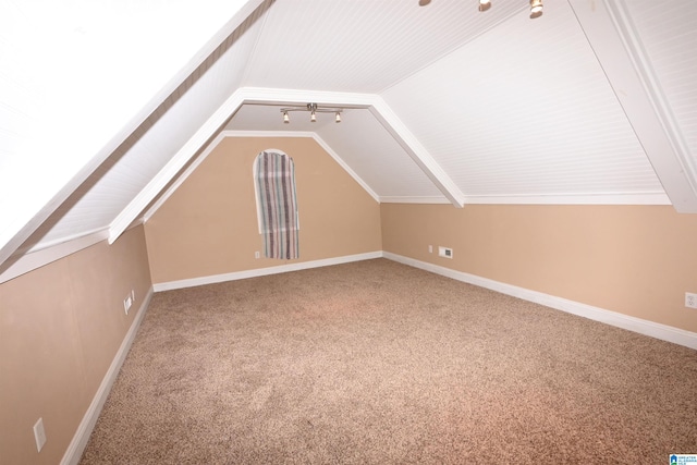 bonus room with carpet flooring and vaulted ceiling