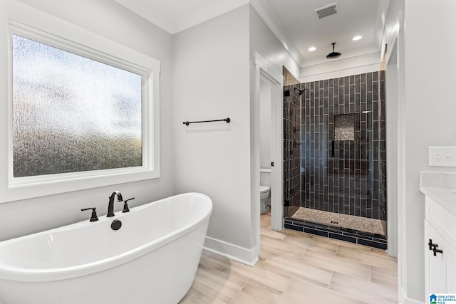 bathroom featuring separate shower and tub and toilet