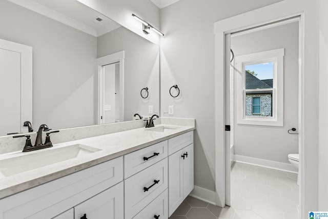 bathroom featuring toilet, vanity, and tile patterned floors