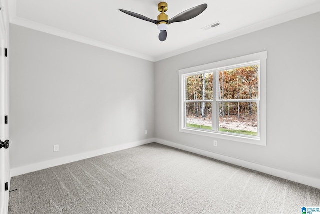 carpeted empty room featuring ceiling fan and ornamental molding