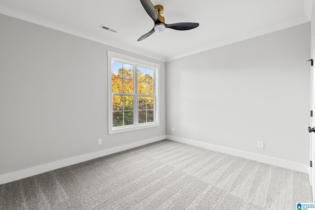 spare room featuring carpet, ceiling fan, and crown molding