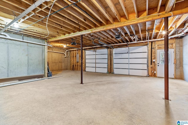 garage with electric panel and a garage door opener