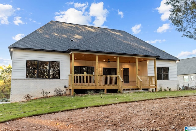 rear view of house with a lawn and ceiling fan