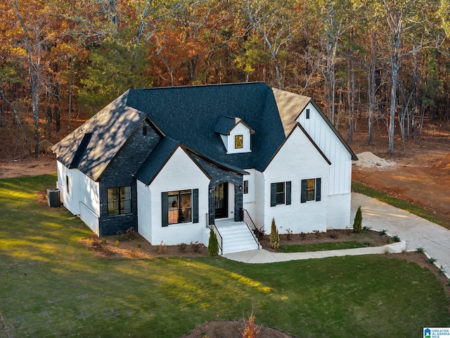 modern farmhouse style home featuring central AC and a front lawn