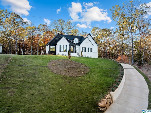 modern inspired farmhouse with a front lawn