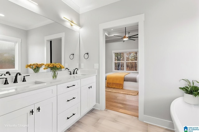 bathroom featuring a wealth of natural light, crown molding, vanity, and ceiling fan