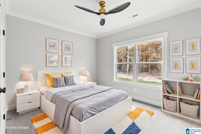 carpeted bedroom with ceiling fan and crown molding