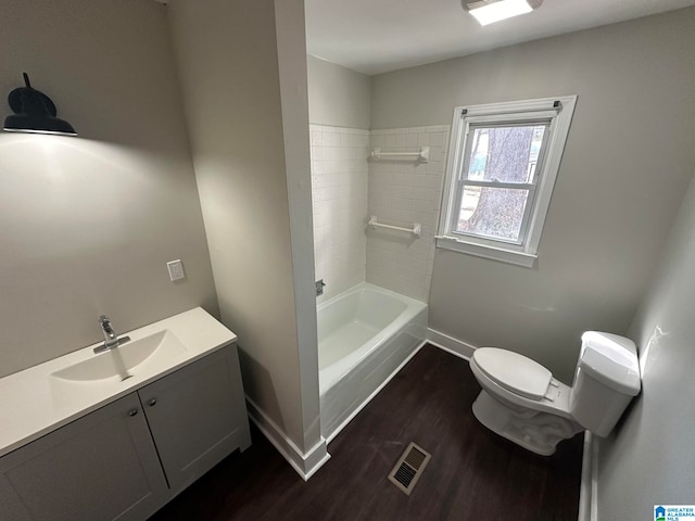 full bathroom featuring vanity, hardwood / wood-style flooring, toilet, and tub / shower combination