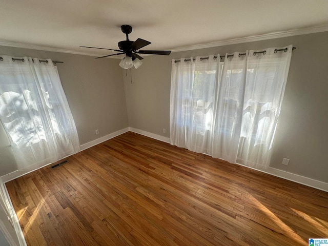 empty room featuring hardwood / wood-style floors, ceiling fan, and crown molding