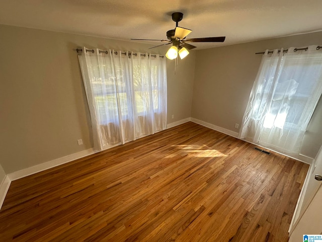 unfurnished room with hardwood / wood-style floors and ceiling fan