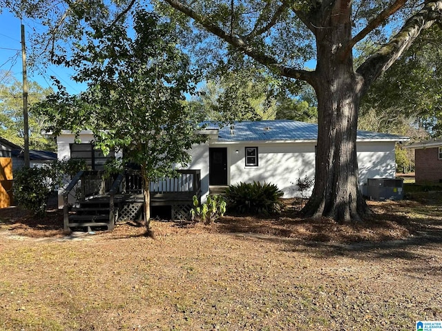 view of front of home with a deck and central air condition unit