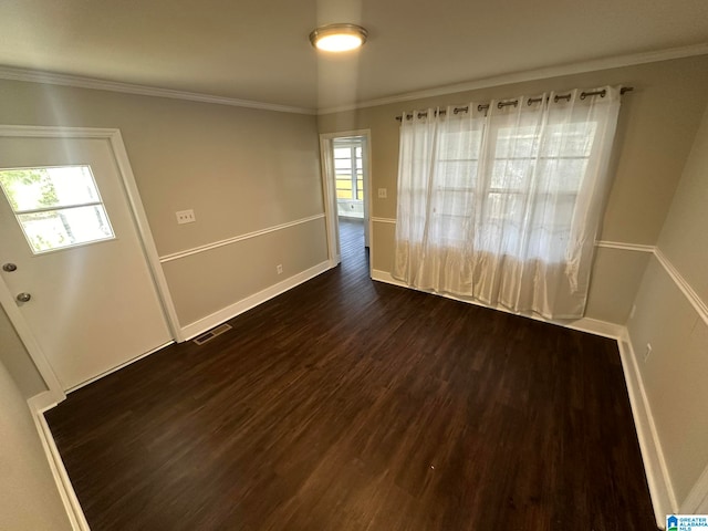 unfurnished room featuring ornamental molding and dark hardwood / wood-style floors