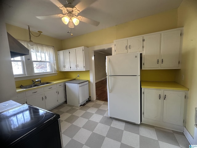 kitchen featuring white cabinets, white refrigerator, sink, and black electric range