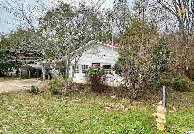 view of home's exterior with a lawn and a carport