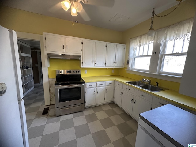 kitchen featuring ceiling fan, sink, white refrigerator, stainless steel electric stove, and white cabinets