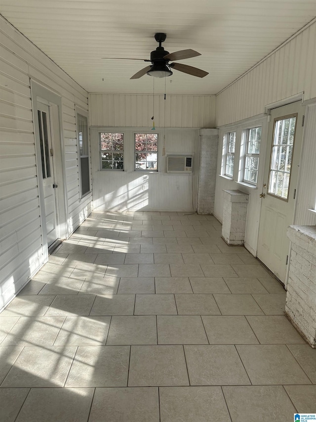 unfurnished sunroom with ceiling fan and a healthy amount of sunlight