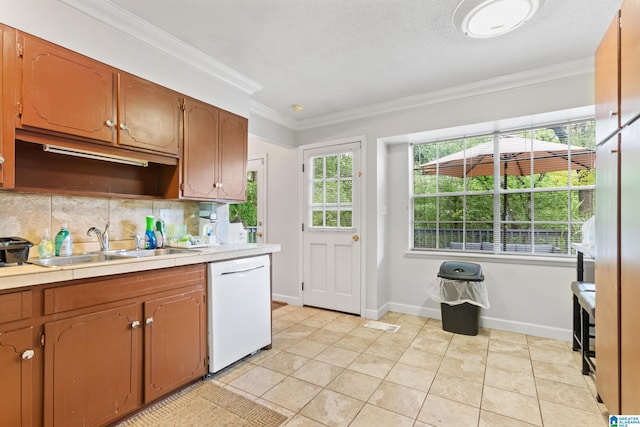 kitchen with sink, ornamental molding, tasteful backsplash, light tile patterned floors, and dishwasher