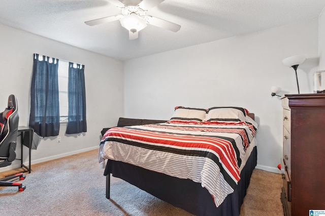 carpeted bedroom with a textured ceiling and ceiling fan