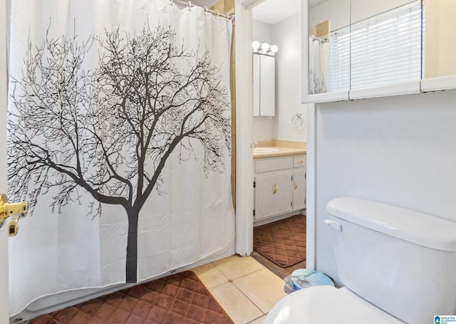 bathroom with tile patterned flooring, vanity, and toilet