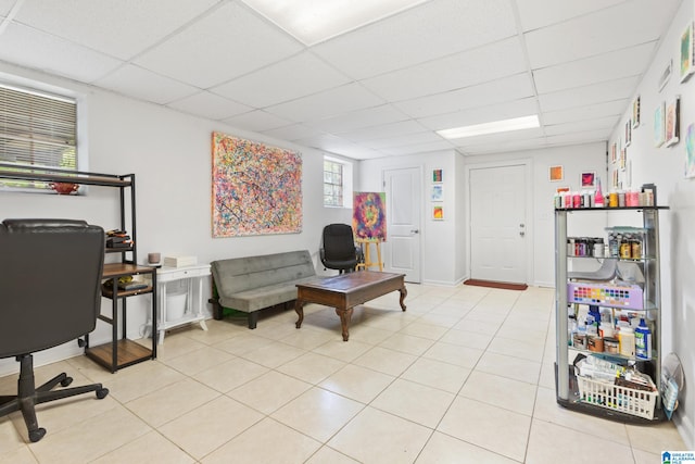 tiled home office with a paneled ceiling