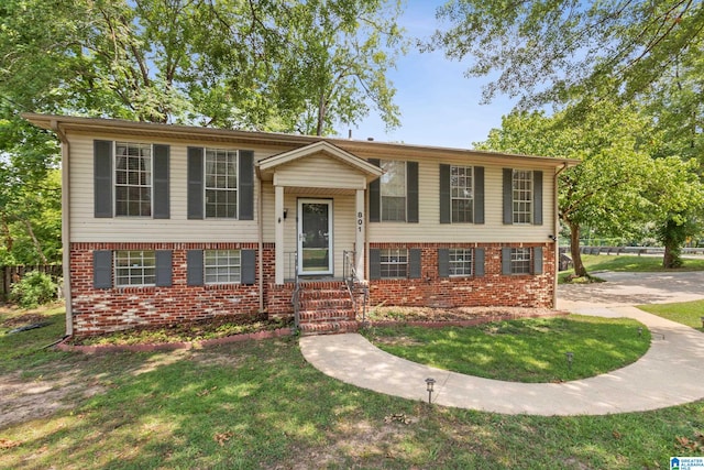 raised ranch featuring a front lawn