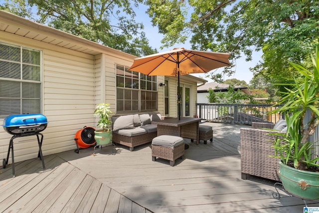 wooden terrace featuring grilling area and an outdoor hangout area