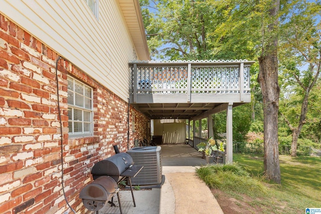 view of patio / terrace with central AC unit and a wooden deck