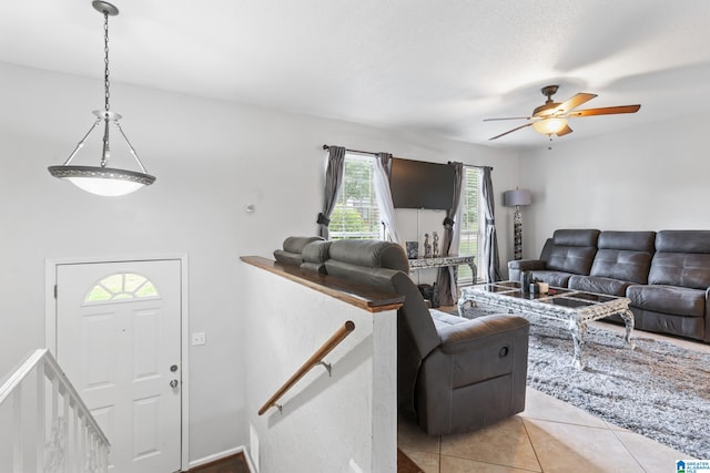 tiled living room featuring ceiling fan