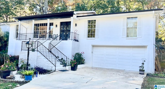 ranch-style home featuring covered porch and a garage