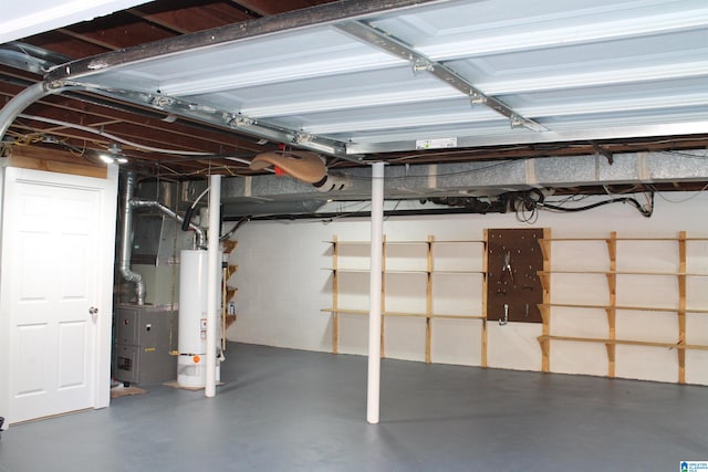 basement featuring heating unit and water heater