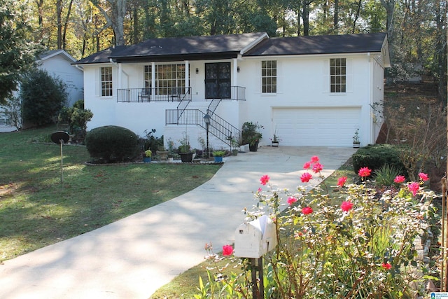 view of front of property featuring concrete driveway, a garage, stairs, stucco siding, and a front yard