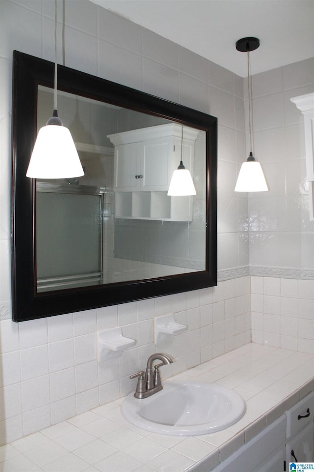 bathroom with decorative backsplash and vanity