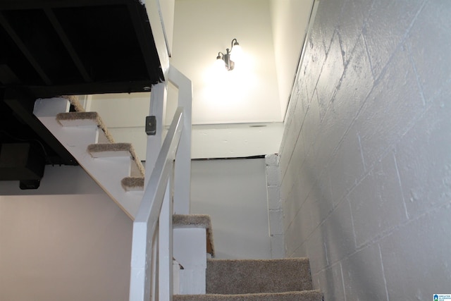 staircase with concrete block wall
