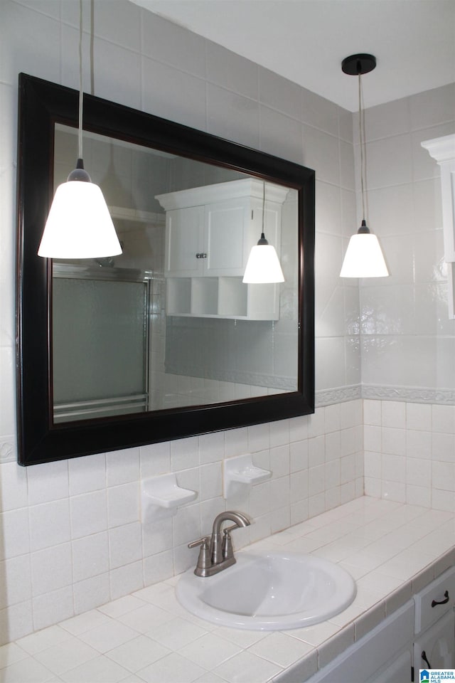 bathroom featuring vanity, tile walls, and tasteful backsplash