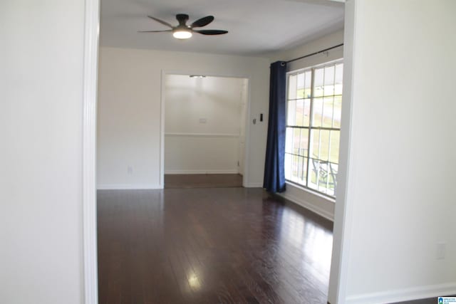 spare room with dark hardwood / wood-style flooring and ceiling fan