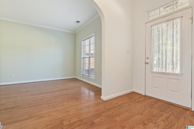 entrance foyer featuring light hardwood / wood-style flooring and crown molding