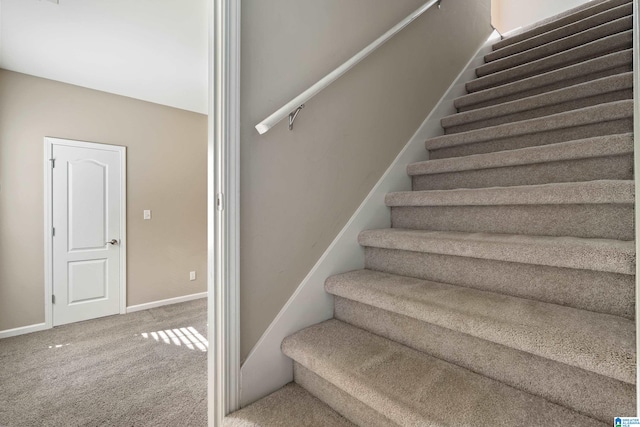 stairs featuring carpet flooring