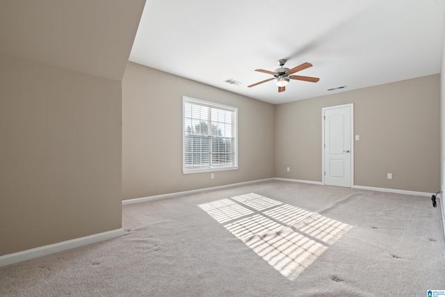 spare room with light carpet and ceiling fan