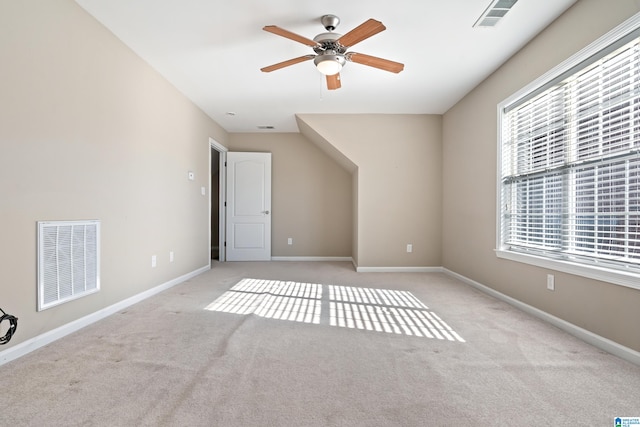 interior space featuring ceiling fan and light carpet