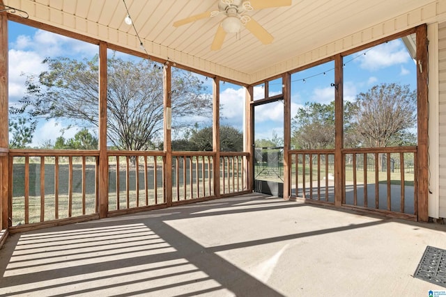 unfurnished sunroom featuring ceiling fan and wooden ceiling