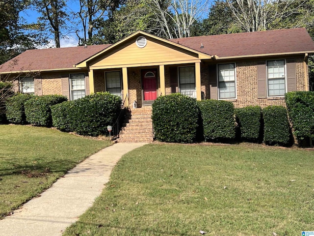 single story home featuring covered porch and a front yard